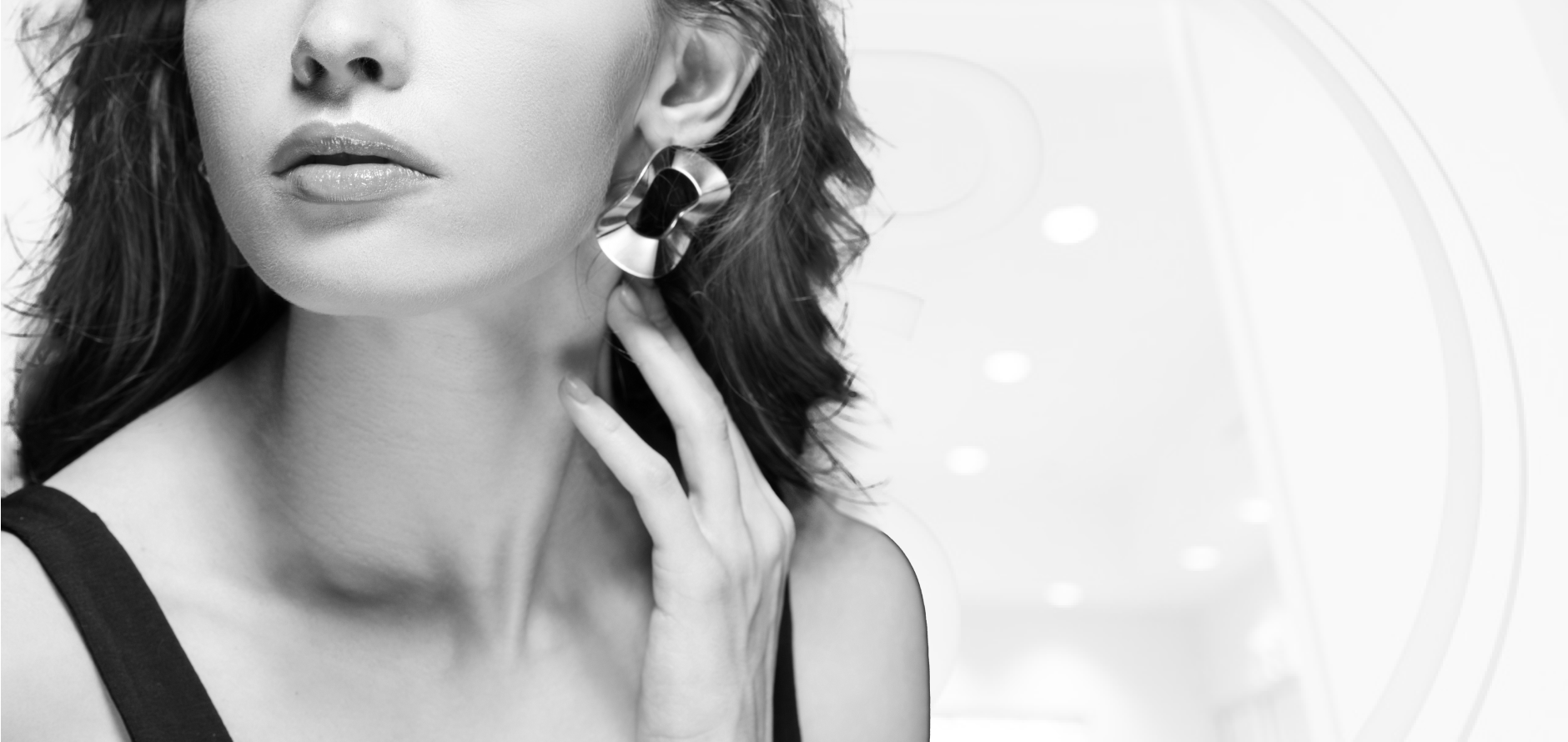 Woman touching her ear to demonstrate professional earlobe reconstruction and piercing repair surgery results.